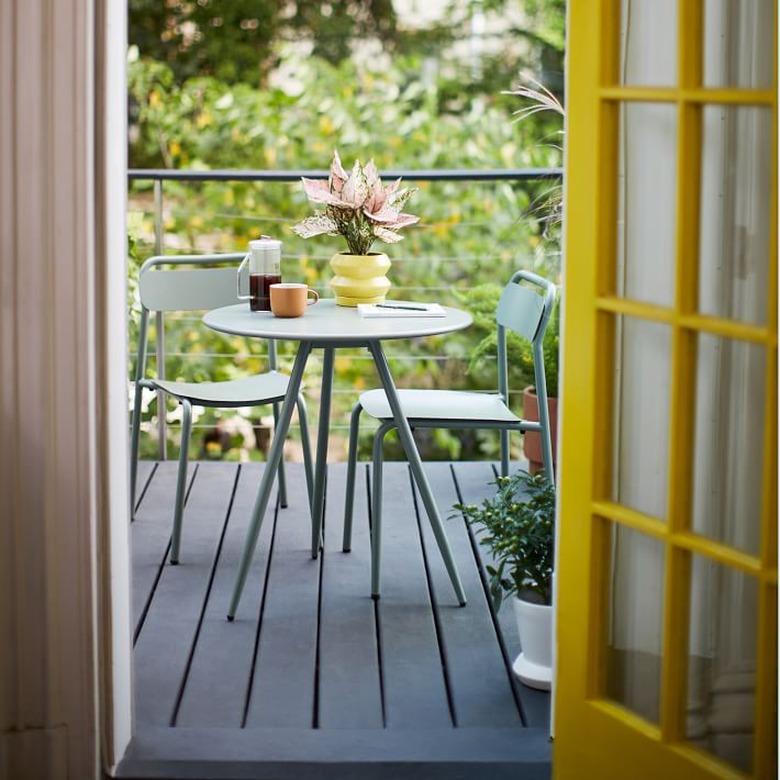 small minimalist balcony idea with green outdoor table and chairs