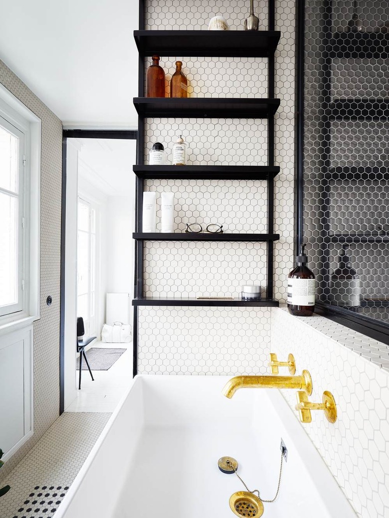 penny tile in bathroom with minimalist bathroom storage and gold faucet