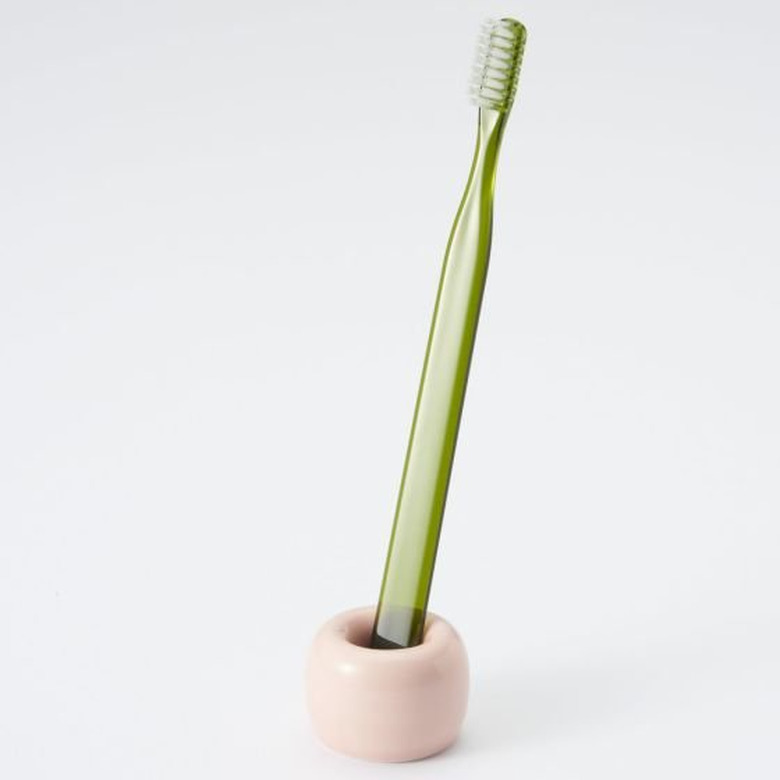 pastel minimalist bathroom toiletries with porcelain toothbrush stand