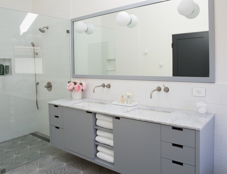 minimalist bathroom vanity with gray cabinets and large mirror