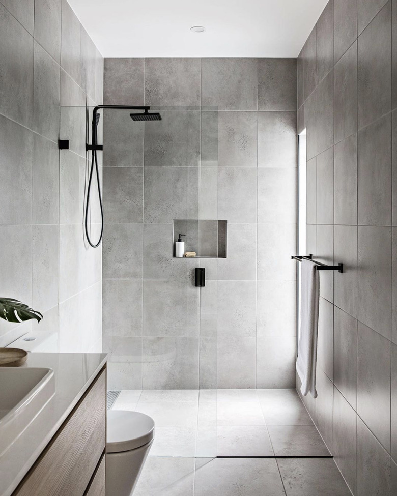 Gray tiled minimalist bathrooms with matte black fixtures