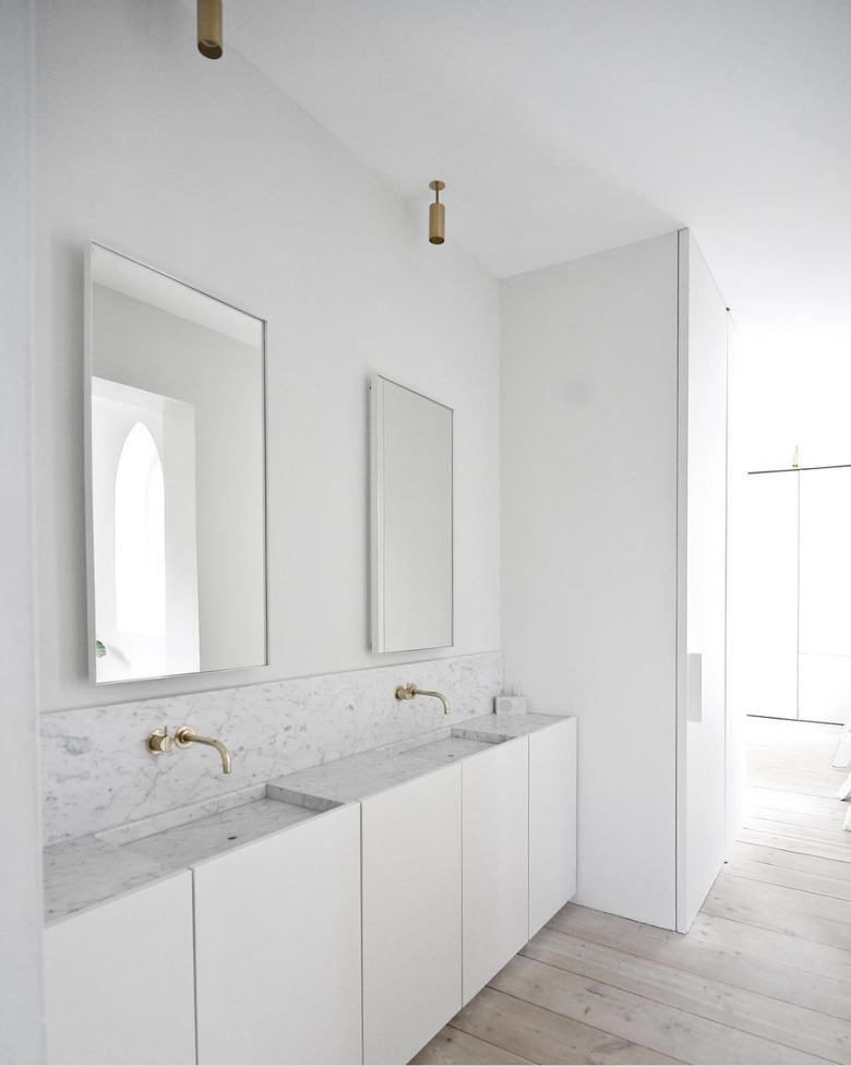 White minimalist bathrooms with brass fixtures