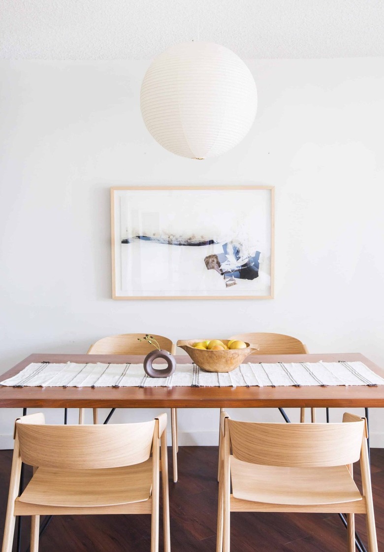 white minimalist dining room with paper lantern