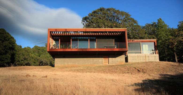 boxy house exterior on raised platform