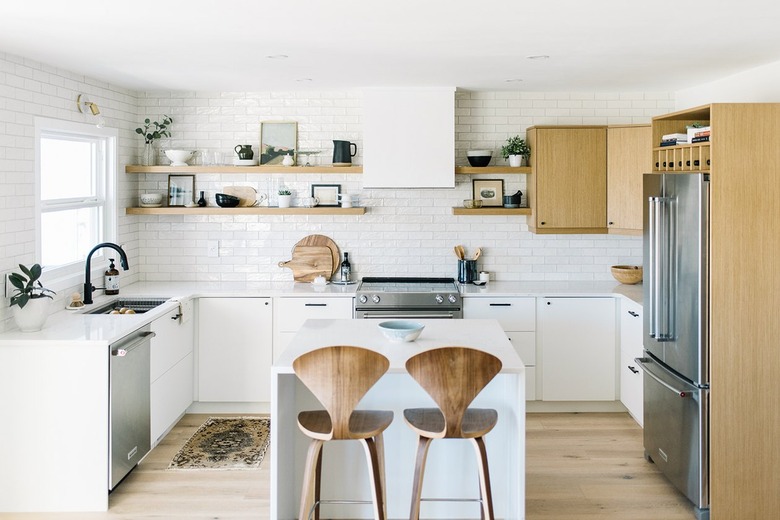 white kitchen with wood midcentury bar stools