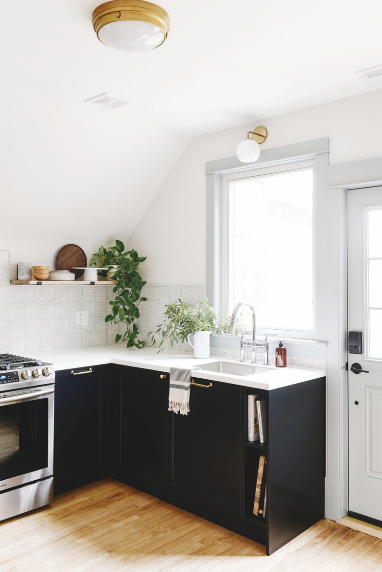 white modern kitchen with black cabinets and patterned backsplash