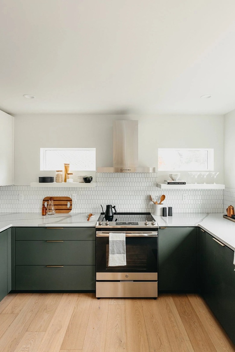 green and white modern kitchen with white tile backsplash