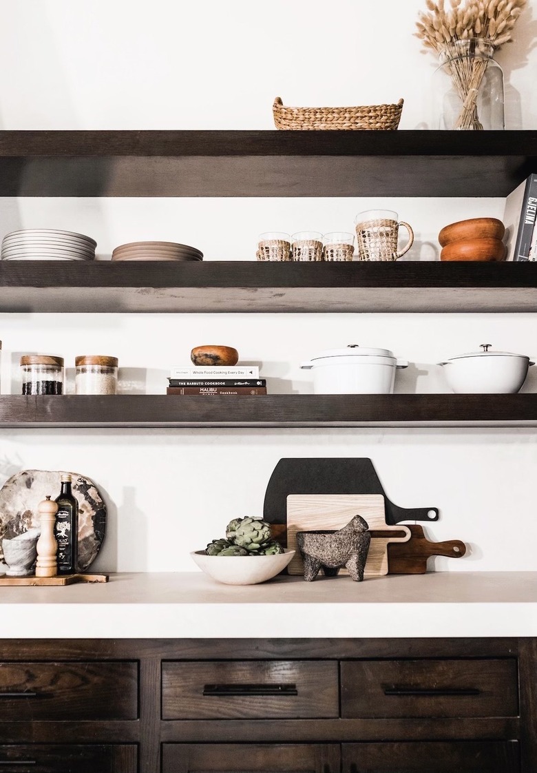 dark wood shelves and cabinets with kitchen essentials