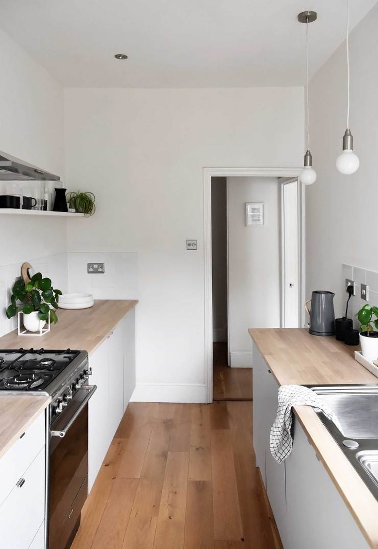 modern minimal kitchen with wood countertops and simple pendants