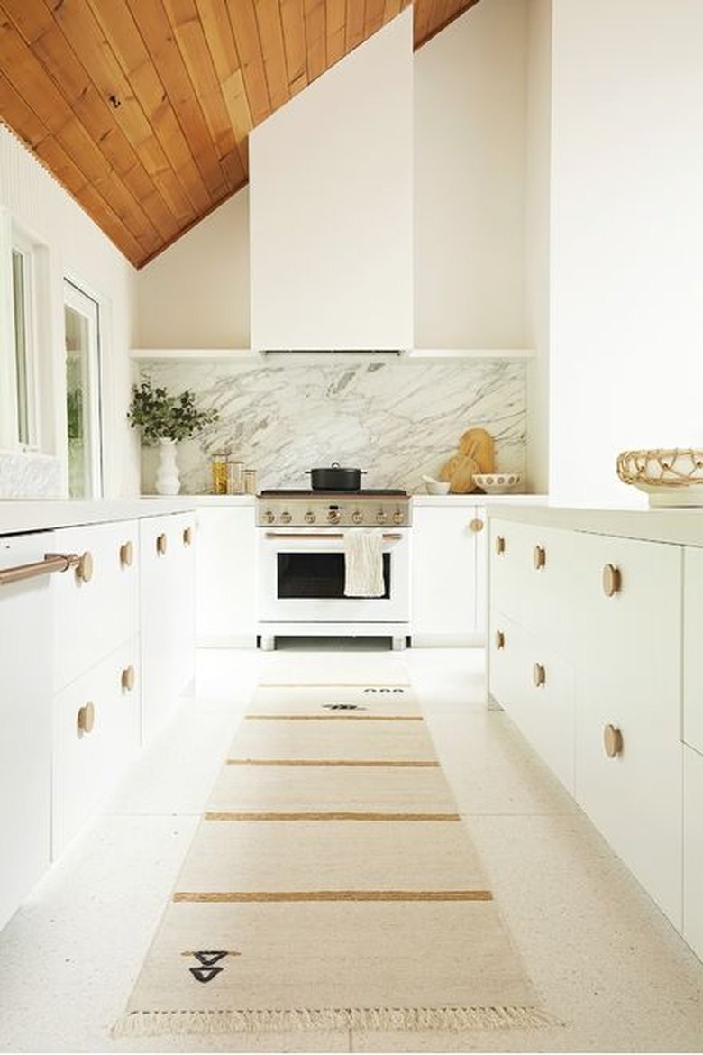 white modern kitchen with striped runner rug