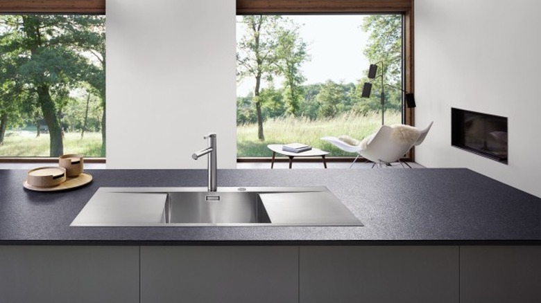 stainless steel minimalist kitchen sink with black counter