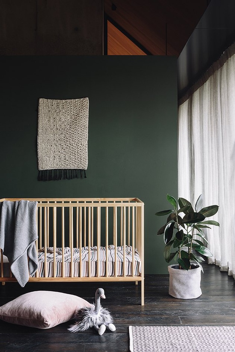 dark green minimalist nursery decor with a light crib