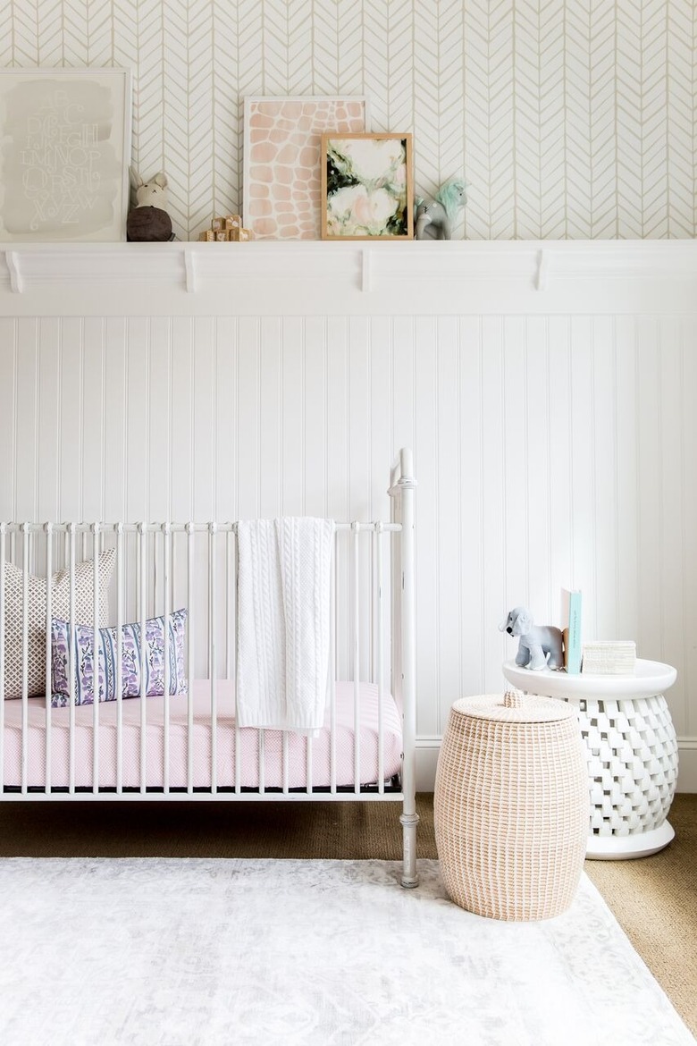 white minimalist nursery decor with wallpaper and white crib