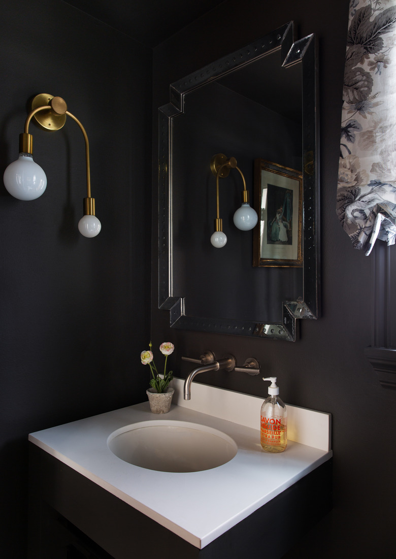 black minimalist room paint colors in bathroom with gold light fixture