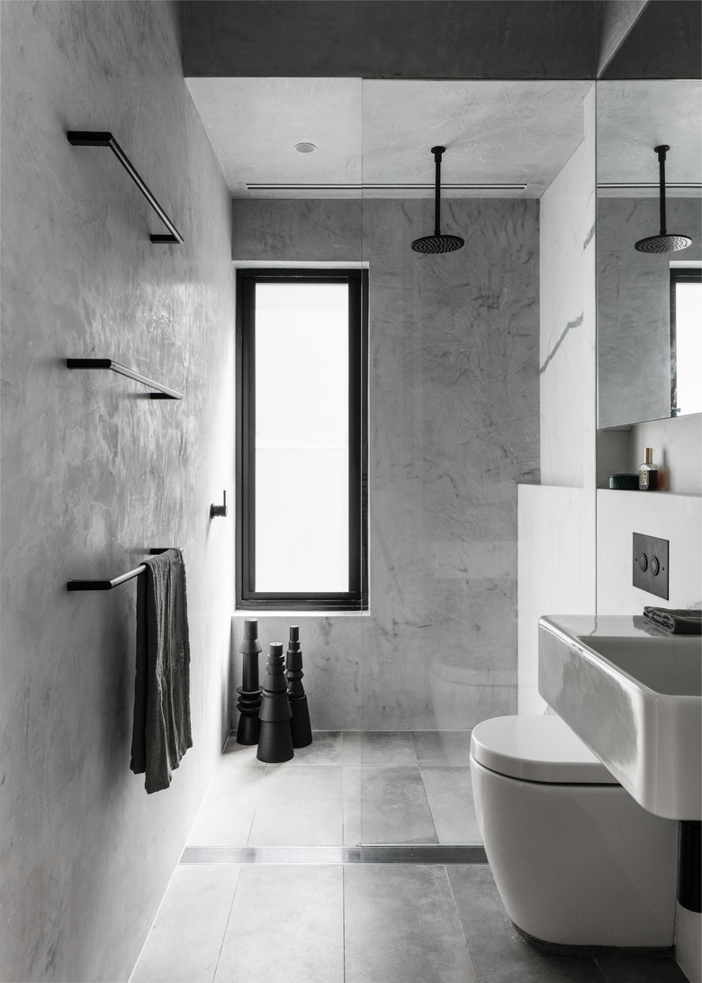 gray minimalist shower with black fixtures and hardware