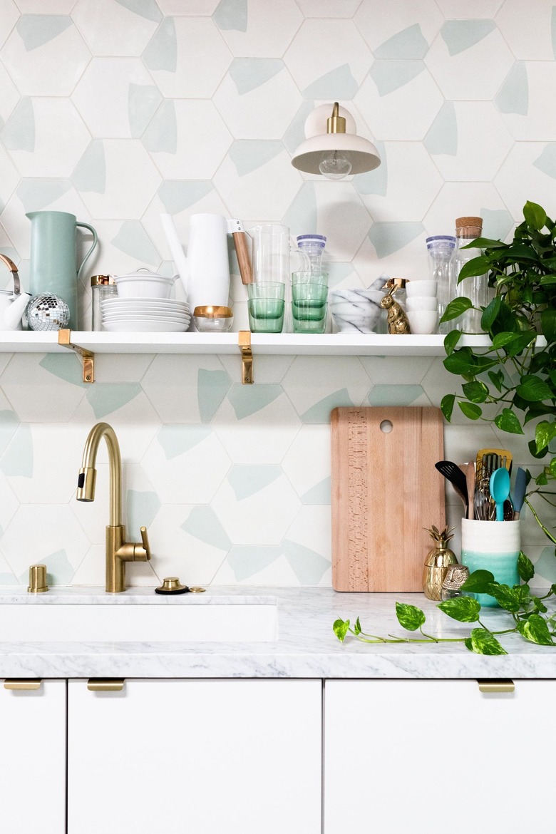 white kitchen with minimalist cabinetry, patterned tile backsplash with open shelving