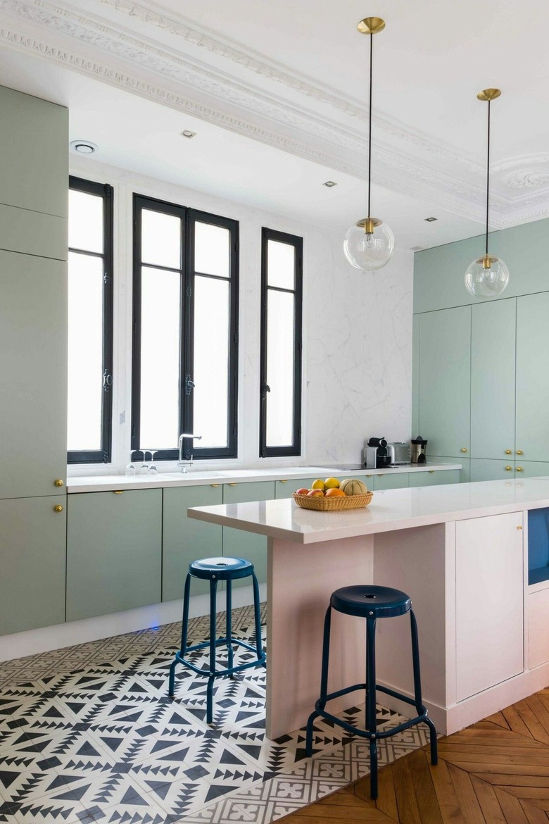 minimalist white kitchen with mint green cabinets, pink kitchen island