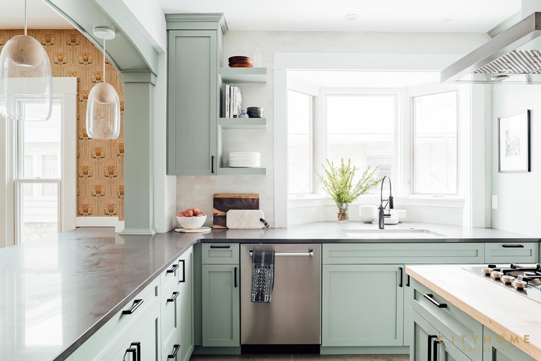 mint green kitchen with retro brown wallpaper