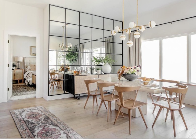 dining room with wall to wall paned mirror