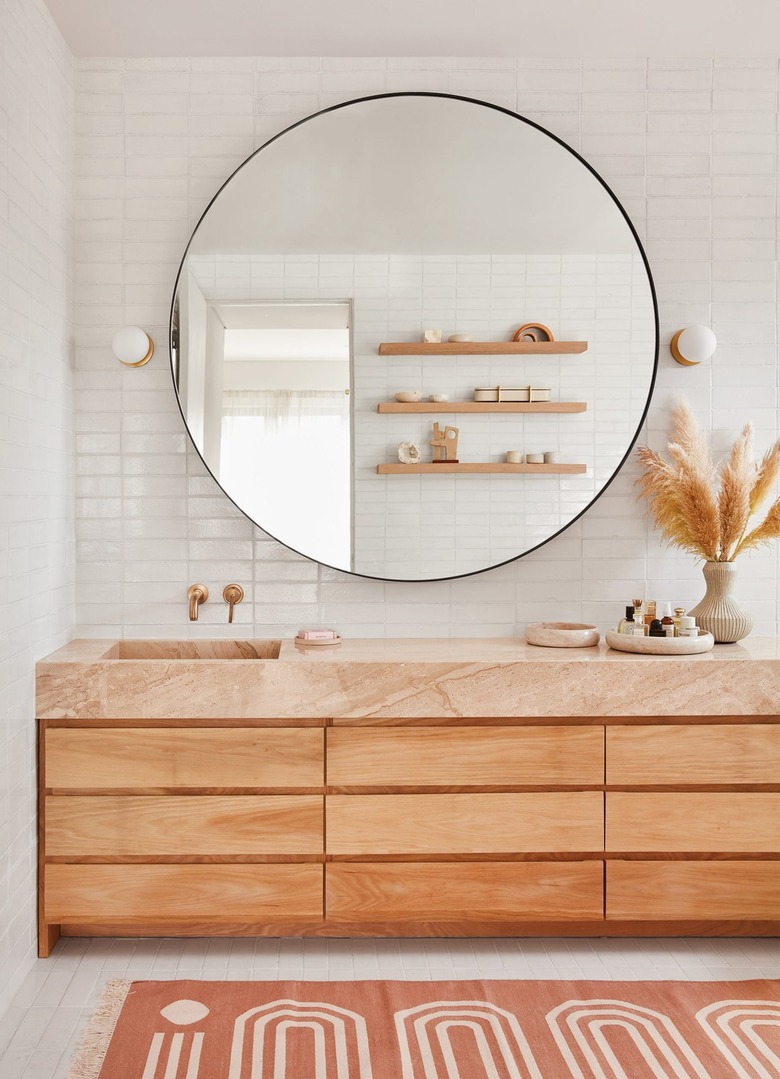 boho bathroom with oversize round mirror