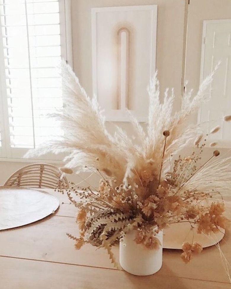 dining table with dried floral arrangement