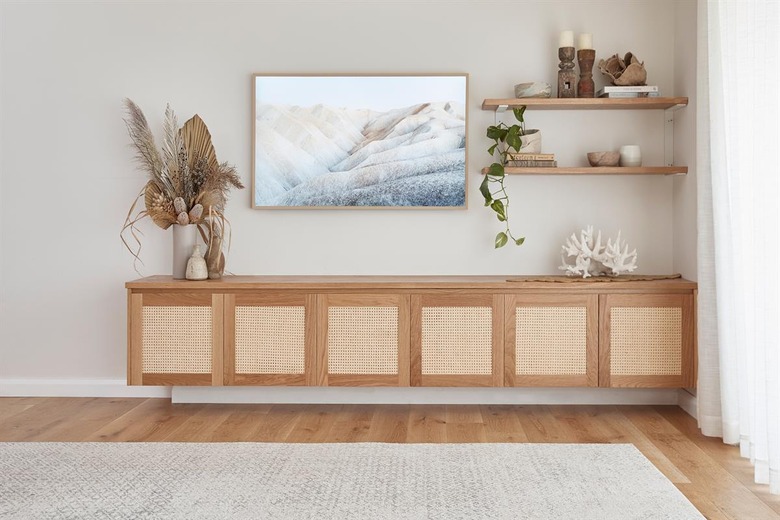 family room storage with wood built in credenza with flat screen tv, and wood floors.