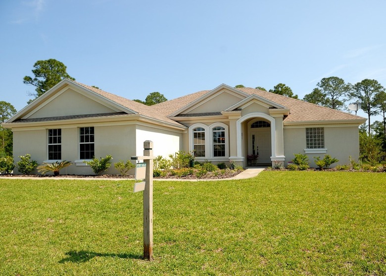 large home with for sale sign in front yard