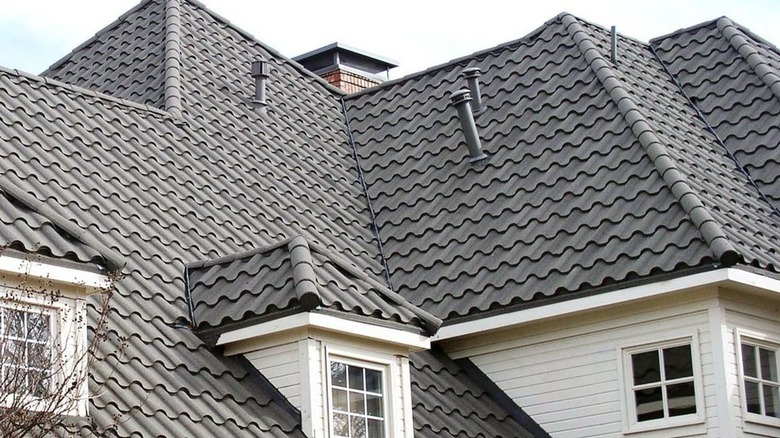 A stone-coated steel roof on a large white house