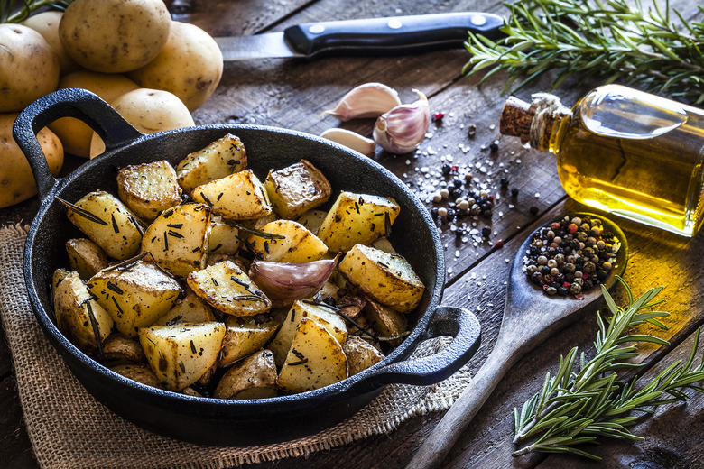 Roasted potatoes on wooden kitchen table