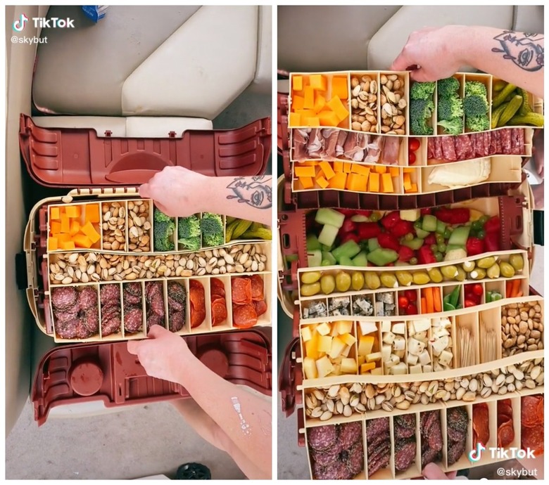 Snackle box in a tool box with crackers, cheese, fruit, and vegetables