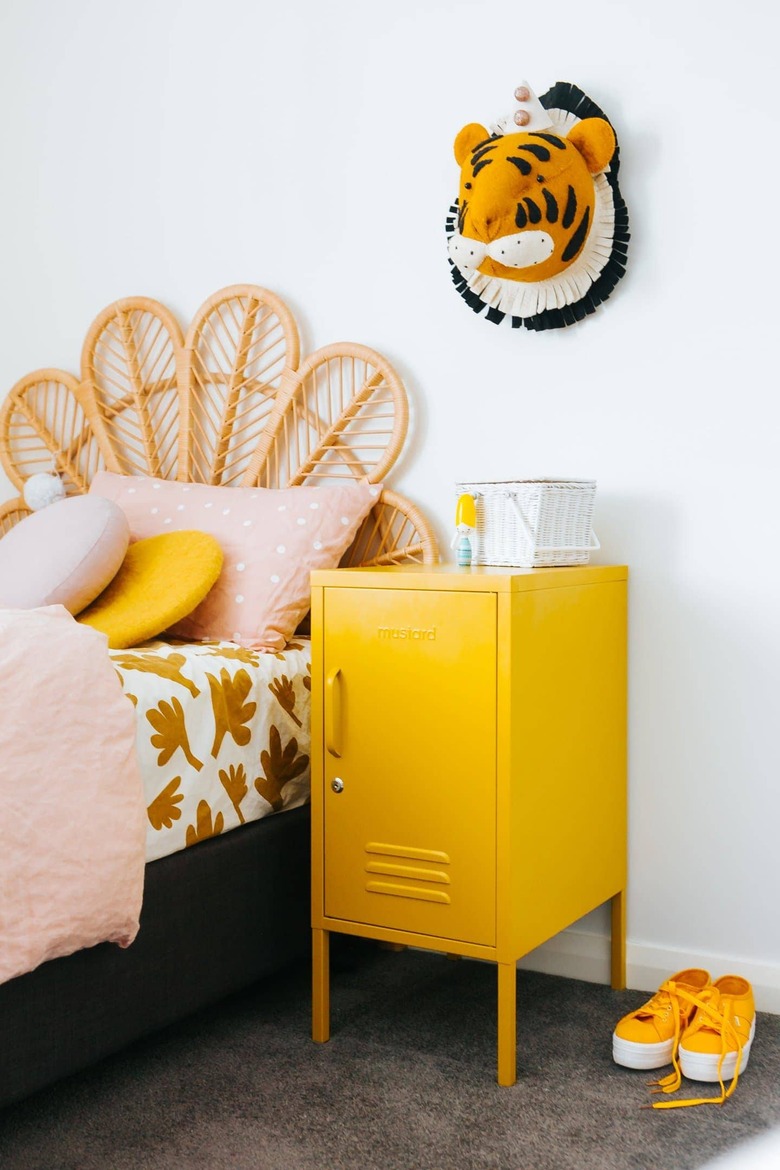 yellow kids room with cane headboard and yellow locker nightstand