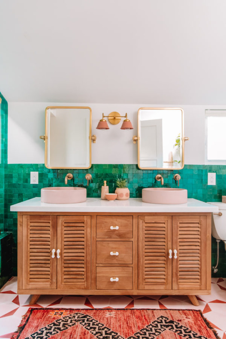 Pink bathroom sink idea with green backsplash and wood vanity cabinet