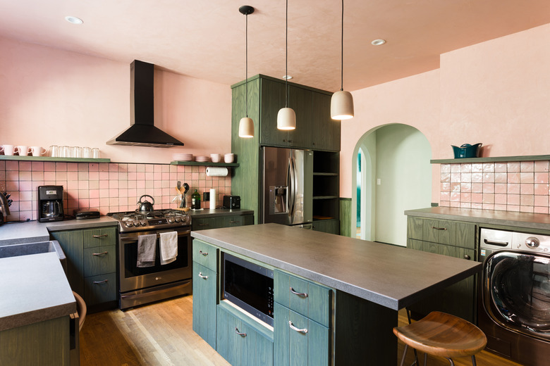 Pink kitchen colors in kitchen with pink tile and green cabinets