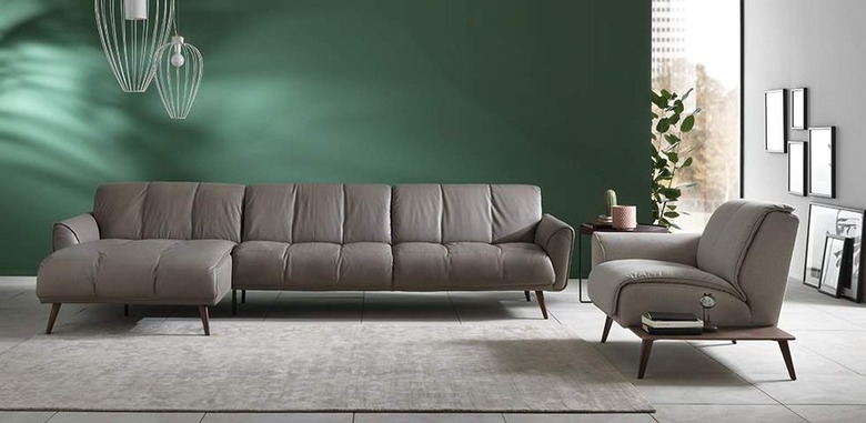 A gray Natuzzi couch in a living room