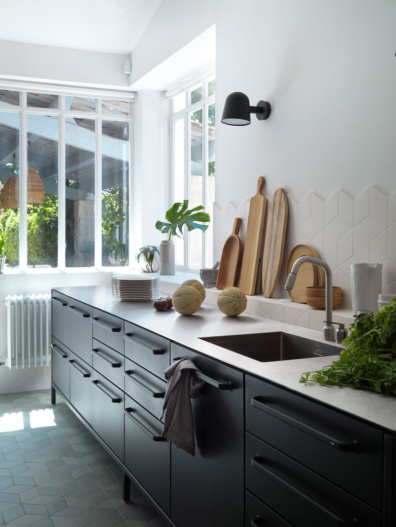 modern kitchen with stainless steel countertop and geometric tile backsplash