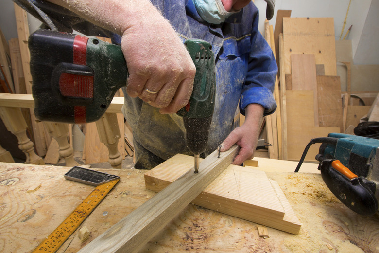 working carpenter with drill.