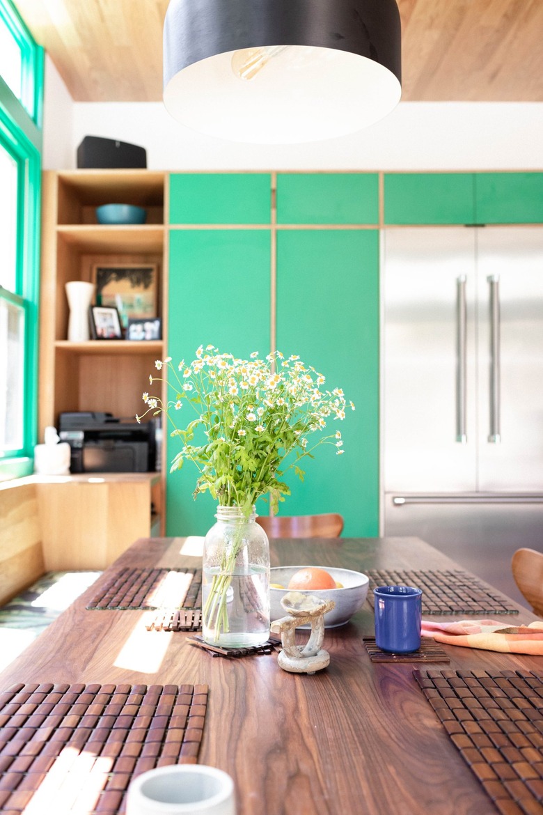 Kitchen wth French door refrigerator and bottom drawer freezer and green cabinets