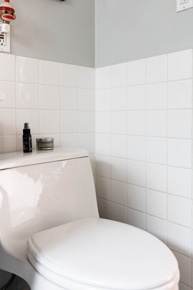 white bathroom tile with toilet