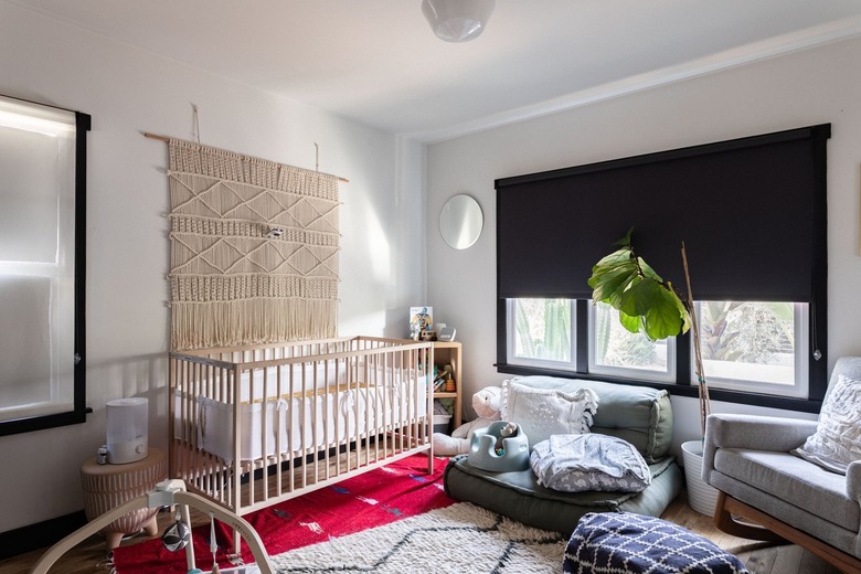 A nursery with a room darkening roller shade