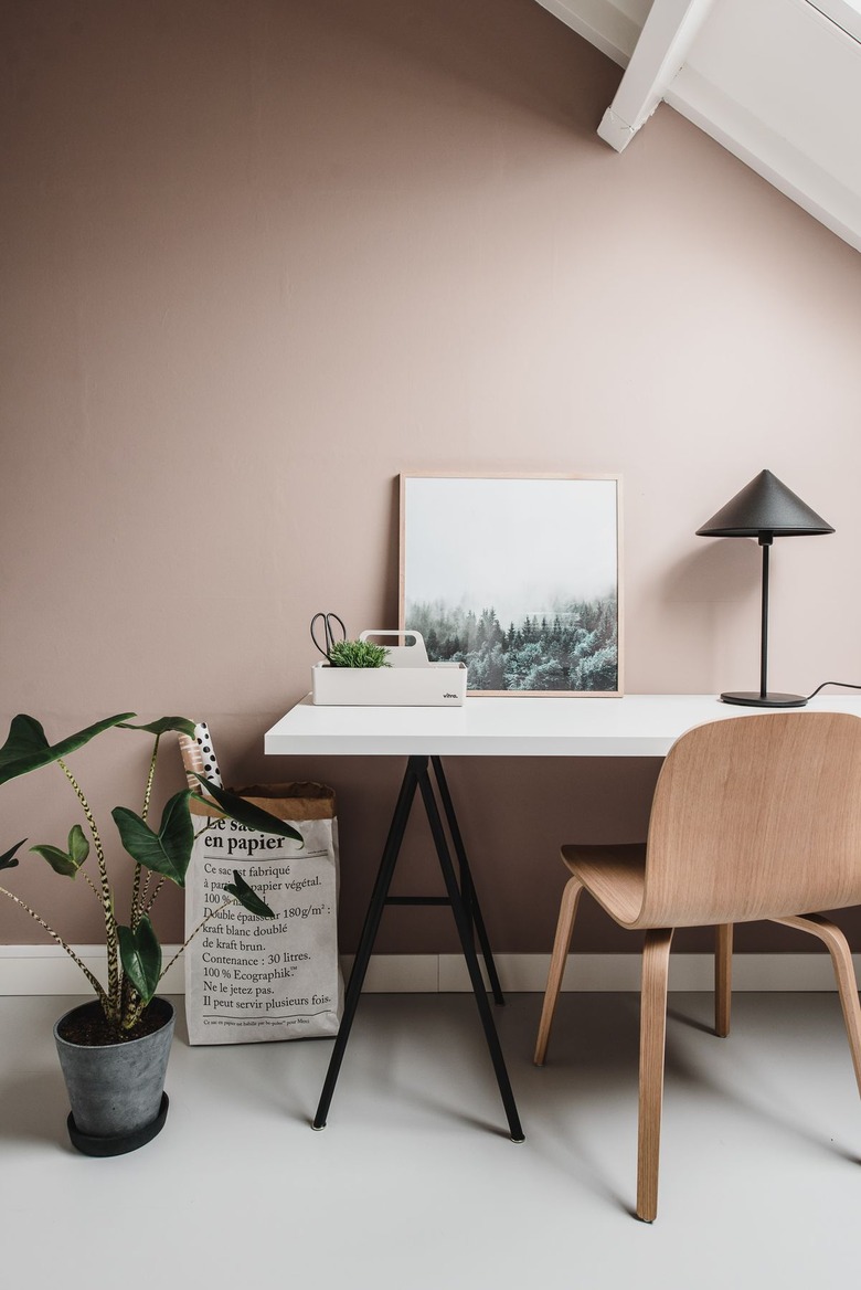 Scandinavian style home office with sleek white desk and blush walls