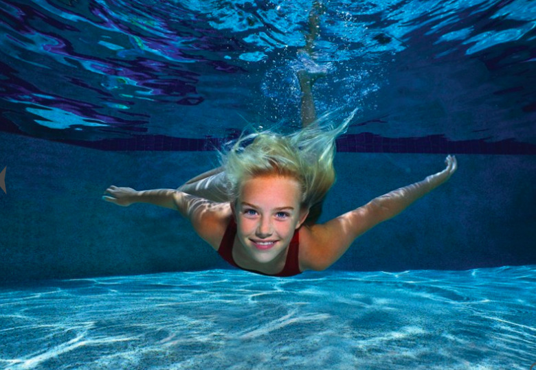 Girl swimming underwater.