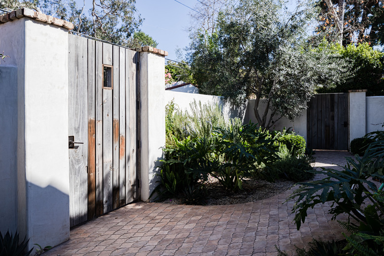 a decorative brick garden path in a Spanish-style home