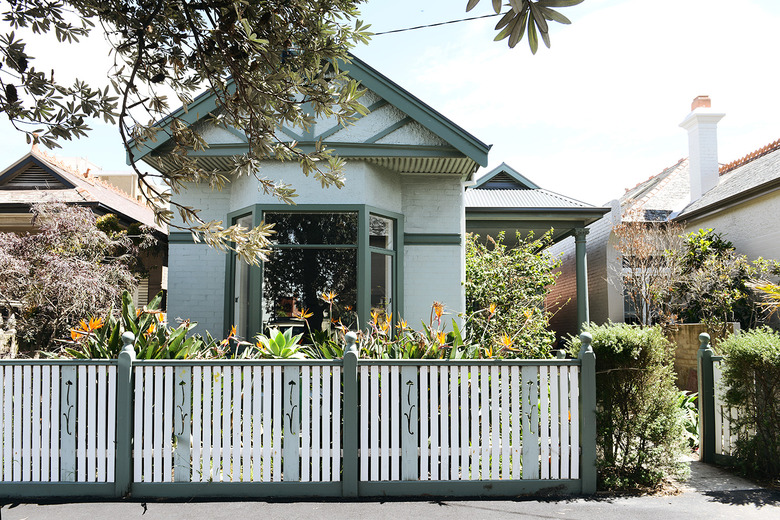 mint green and forest green house with exterior window trim