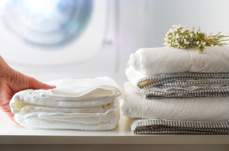 Clean bedding, washing machine in background.