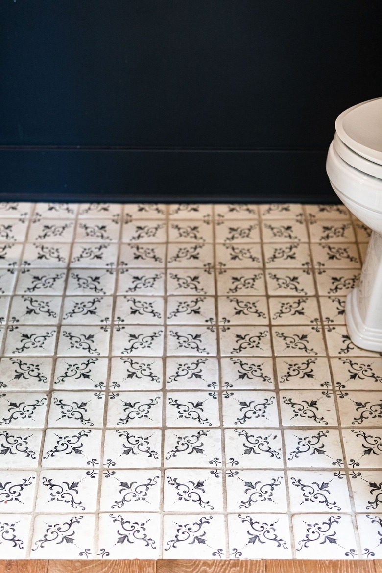 White-blue floral tiles in a bathroom with blue walls