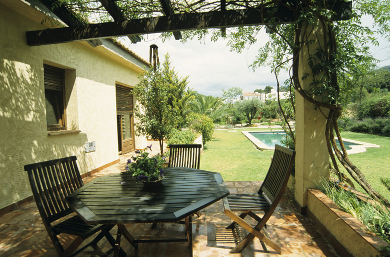 Hardwood garden furniture on terrace outside house