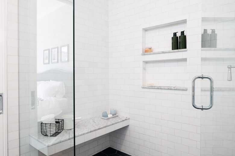 subway tile shower with marble bench