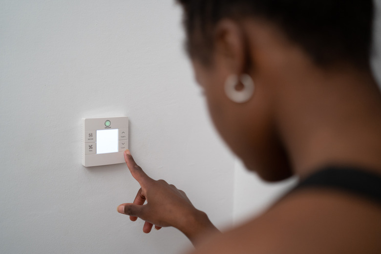 young black woman using home automation at home