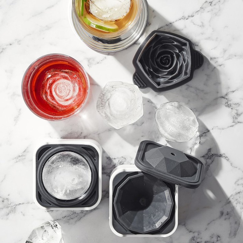 overhead photo of glasses and molds for flower-shaped ice cubes