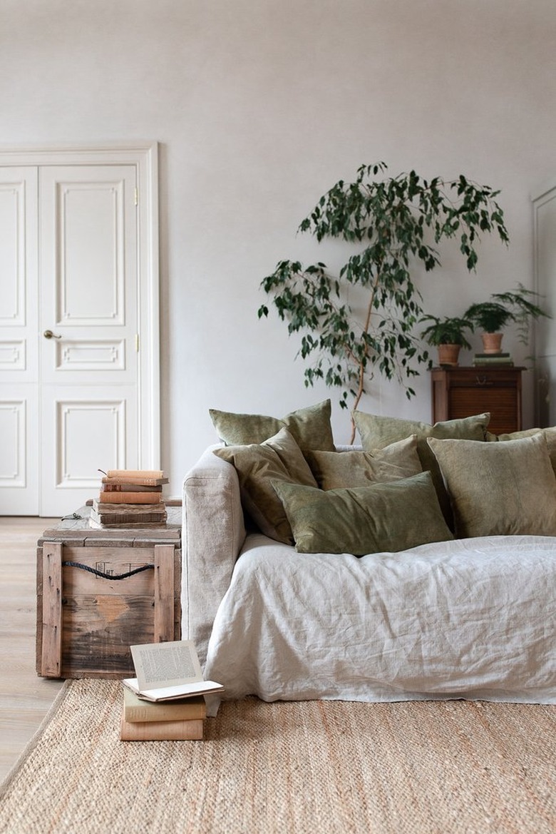 natural decor in a gray room with linen sofa and green pillows